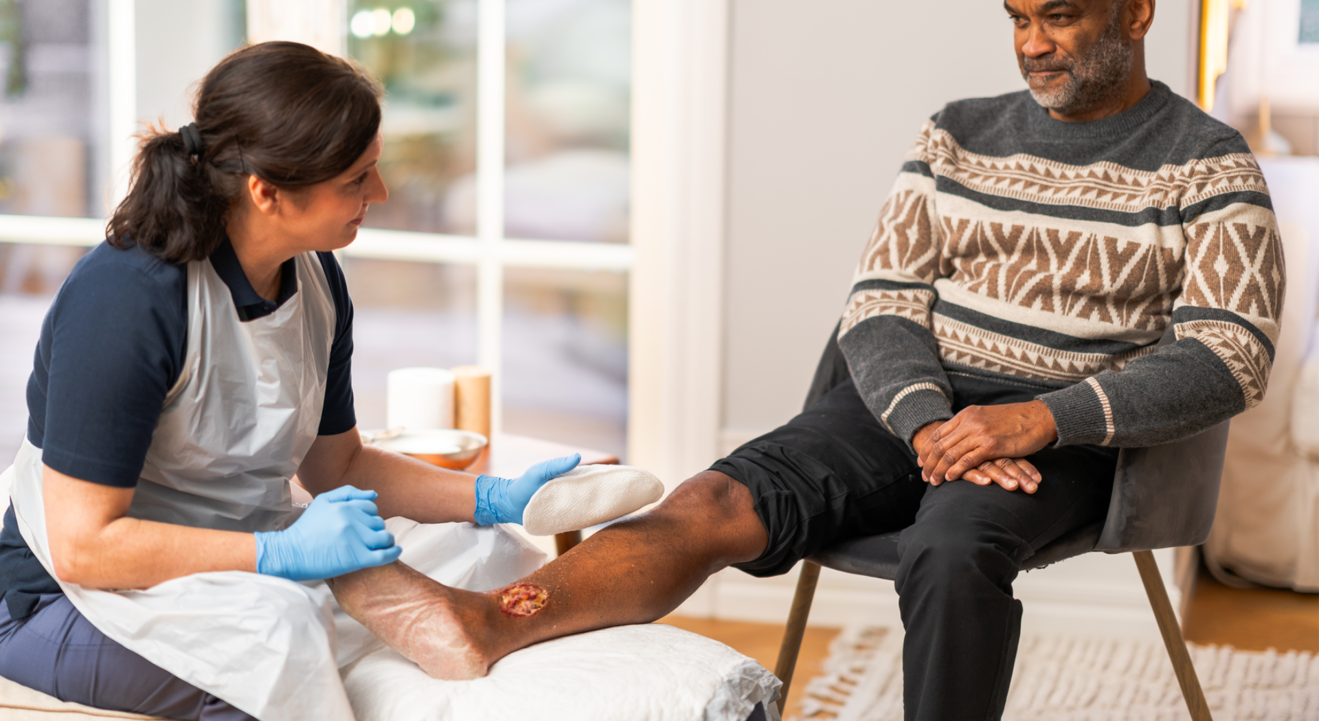 Health care professional using Mepi debripad debridement solution on a male patient