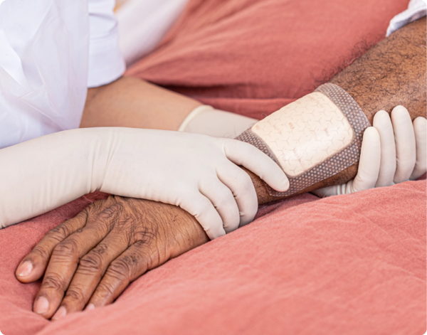 Healthcare professional applying Mepilex Border Flex to patient